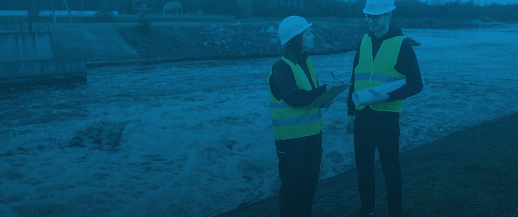 full-shot-engineers-standing-near-river 1-1
